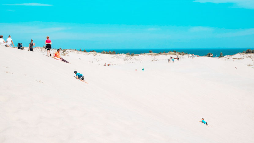 Sand surfing in Leba Poland sand dunes 