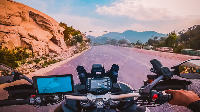 a motorcyclist riding up a mountain road