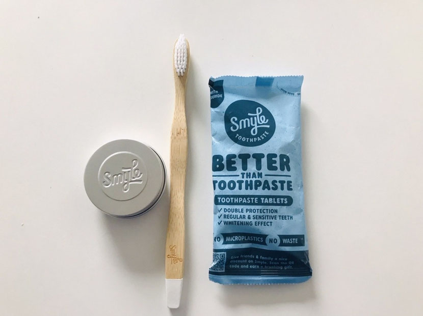 smyle toothpaste review: a metal box, a wooden toothbrush and a pack of tablets