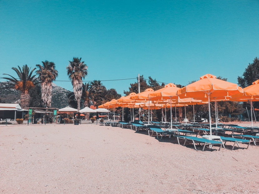 sandy beach with blue flag near Athens