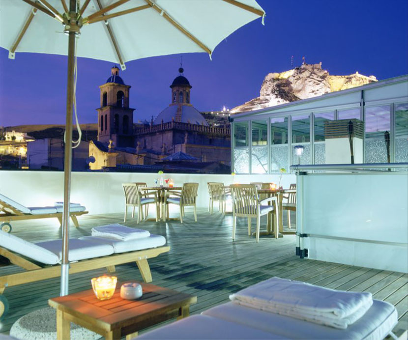 a rooftop terrace with a bar in the Unusual hotel in Alicante Hospes Amerigo