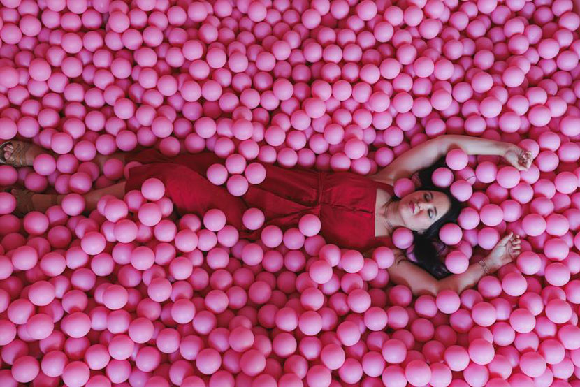 Unusual and fun things to do in Krakow, Poland. In this photo I am in a  ball pool at the bar Bubble Toast 