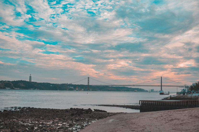 Lisbon promenade and The Ponte 25 de Abril suspension bridge