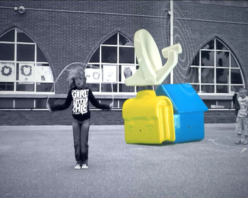 Unidentified Arcade — video still showing a child skipping rope in a playground in front of a brick building, next to colorful abstract object forms.