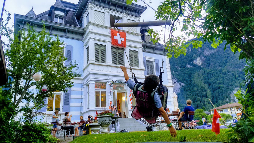 paragliding harness swing during a summer bbq at the Adventure Hostel Interlaken