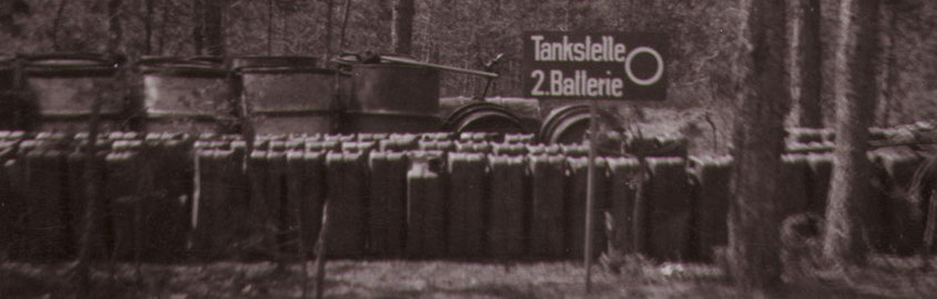 WWII German Army field gas station located in a forest. Note the 20 litre Jerrycan, 200 litre drums and hand pumps.