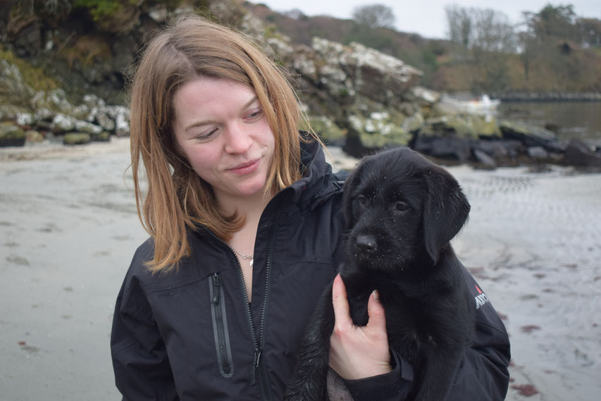 woman and puppy on the beach