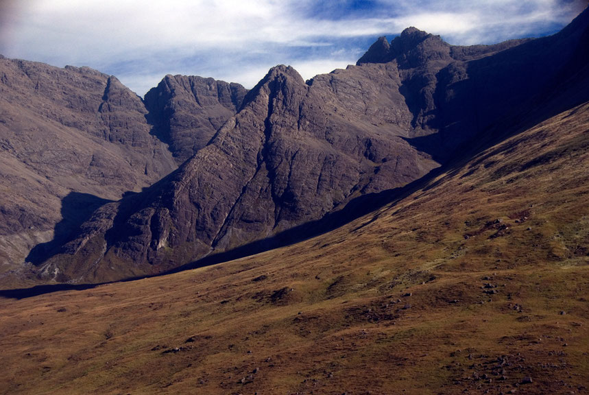 The glaciated Gabbro scenery of the Cuillins with chrarchteristic nothched ridges caused by intrusions of finer-grained dykes into the Gabbro.  This is Sgurr an Fheadain (688m) with Bruach na Frithe (958m) behind. 