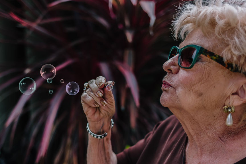 Boo Boo is the coolest grandma in the world. She entertained herself with bubbles when the party was dying down a little.