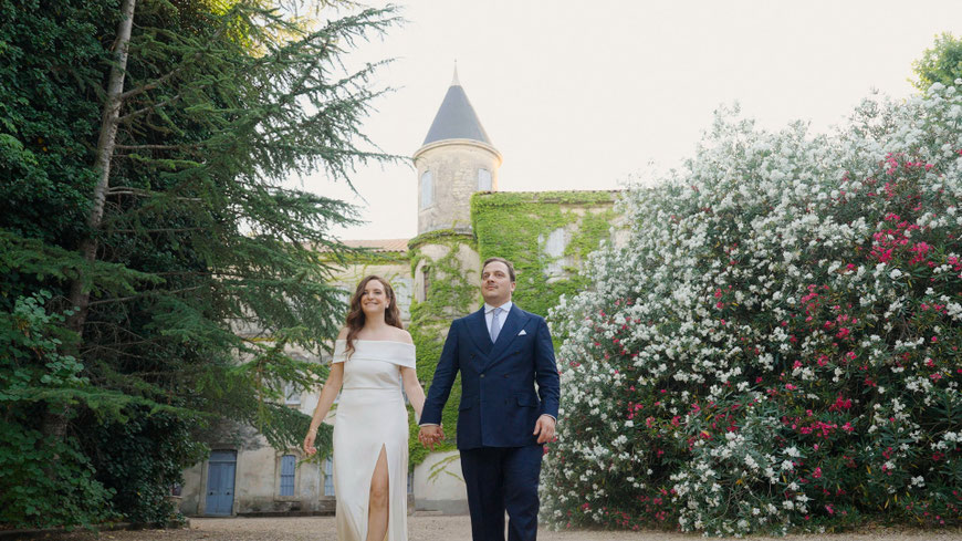 Couple standing in front of the Château de Villele