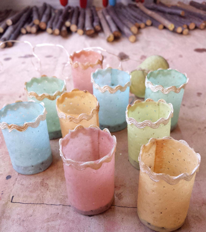 closeup of chinese paper lanterns in shabby chic pastel colours pink, yellow, blue, green. decoratet with lace, handpainted aquacolor, oil varnished