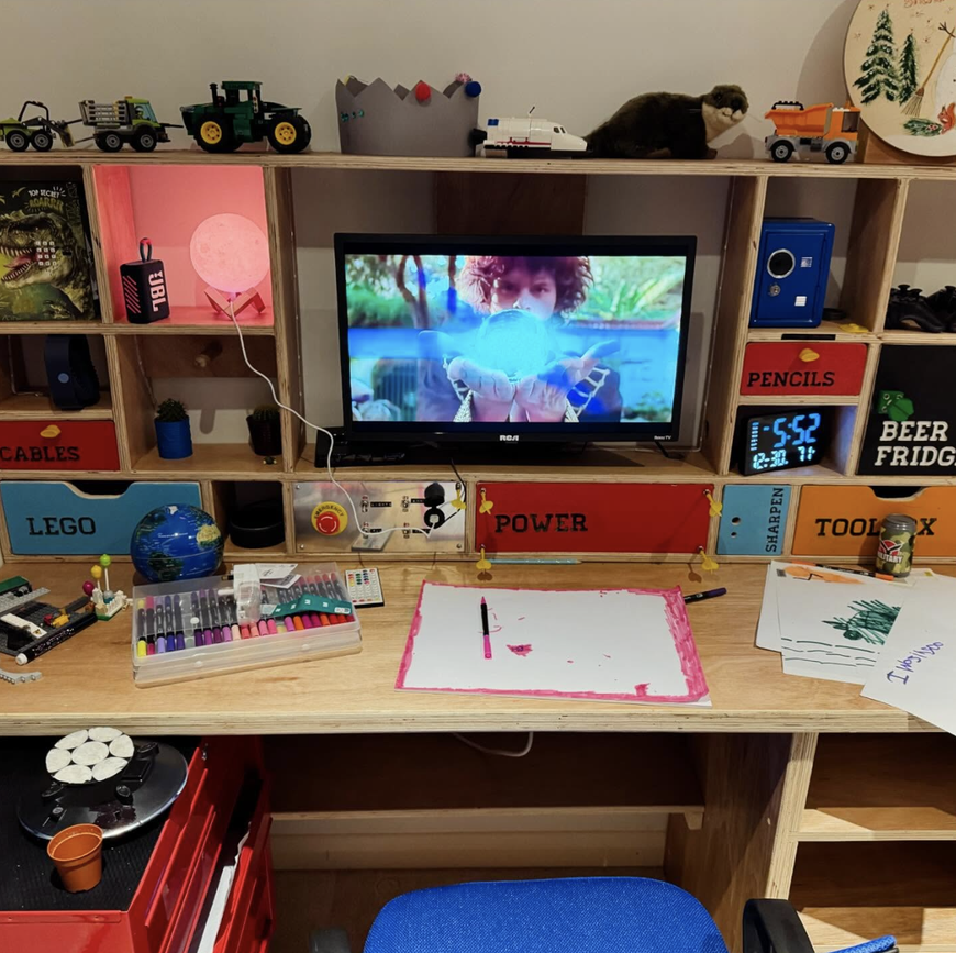 Custom plywood desk with integrated shelving, control panel and workshop storage