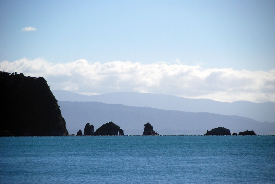 The rock formations off Abel Tasman Point and the ranges to the west.