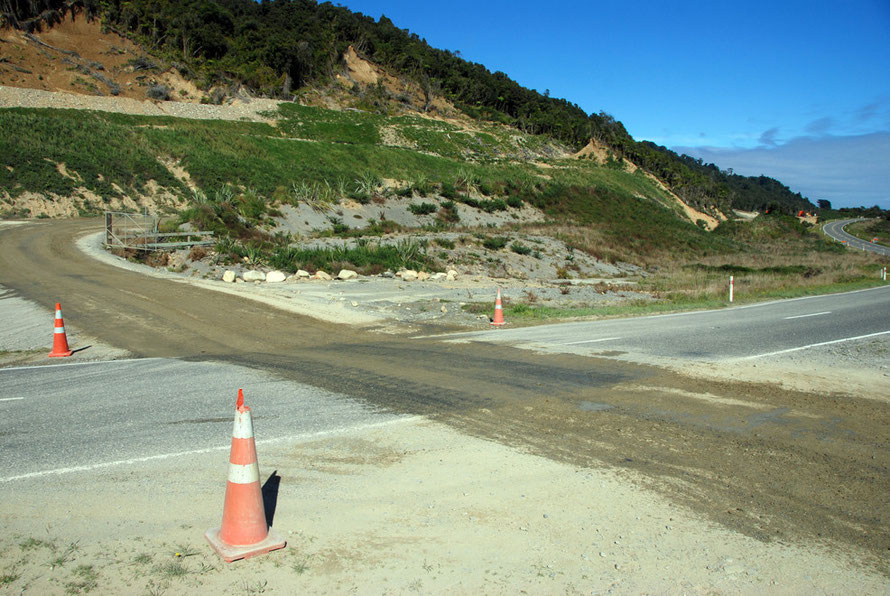 Who's right of way: mining truck tracks across State Highway 6 at Donoghues just south of Ross. Raised gold bearing beach sands and glacial moraines provide potentially rich pickings for West Coast go