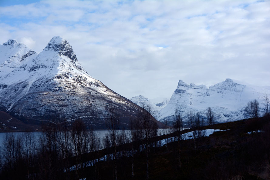 More of the fierce mountain landscape of the Lyngen Line in April 2015 looking towards Storfjord village and Kitdalen behind. Hatten peak on the lefdt at 1060m and the distant peak of Otertinden (1340m) on the right towering above Singnaldalen.