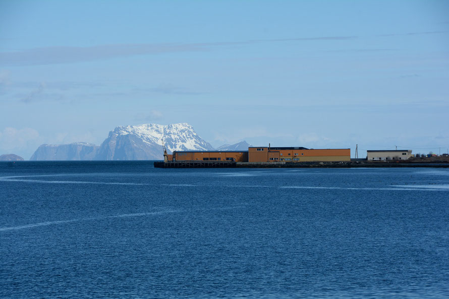 Sandneset fish plant on the Nord-Lenangen inlet of the Ullesfjord on the west side of the Lyngen Peninsula with Nord-Fulgøya Island in the background.