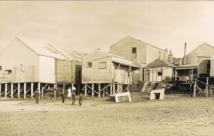 The undercut buildings of Revell Street in 1914 after sea flooding (click for link at postcard.org.nz