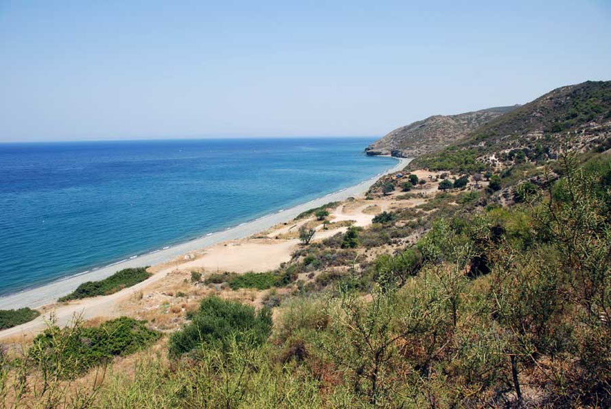 Early afternoon June saturday empty beach at Kato Pyrgos under an implacable sun