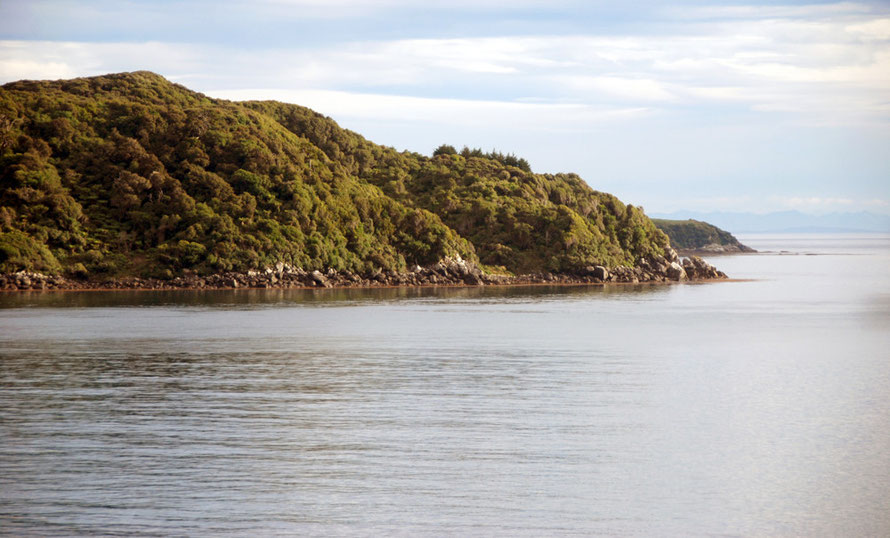 Looking across to Bragg Point, Dead Man Beach (around corner) Horseshoe Point and thedistant mountains of the South Island from Ackers Point path, Stewart Island.