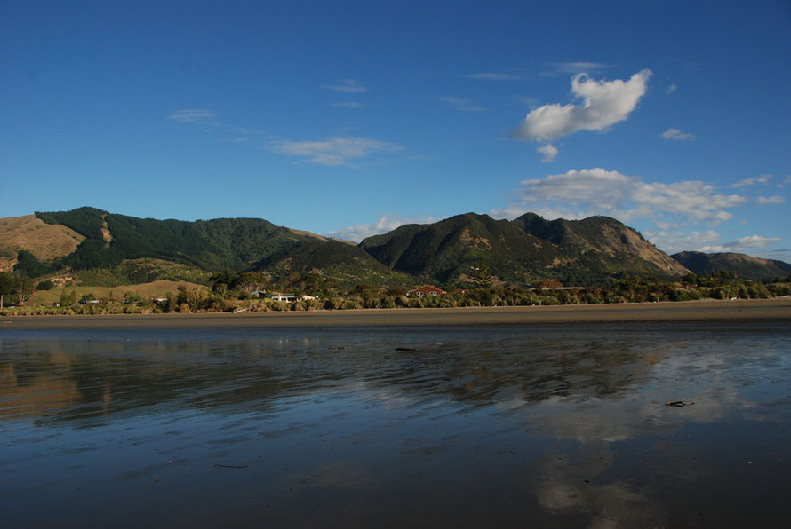 The sheen and reflections on the intertidal sands at Pohara Beach.