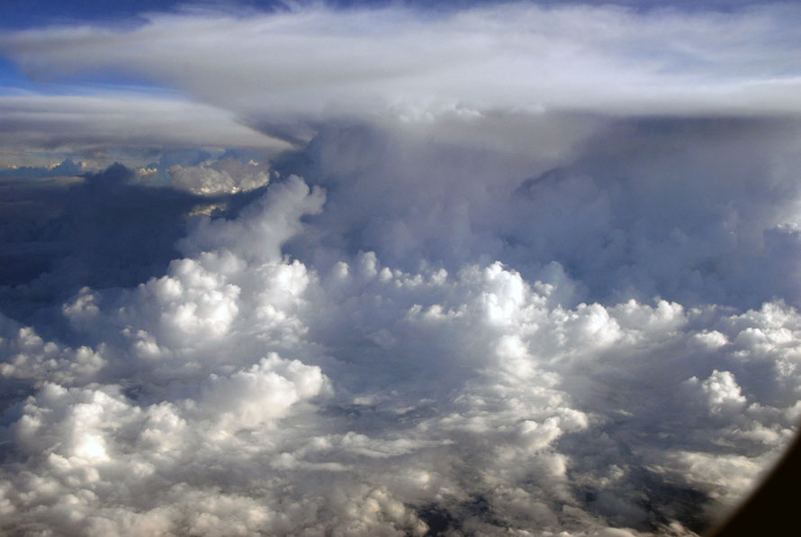 Staggering cloud formations and hefty turbulence towering over our plane flying at 36,000 feet above the 4884 m high mountains of Papua New Guinea on the return journey