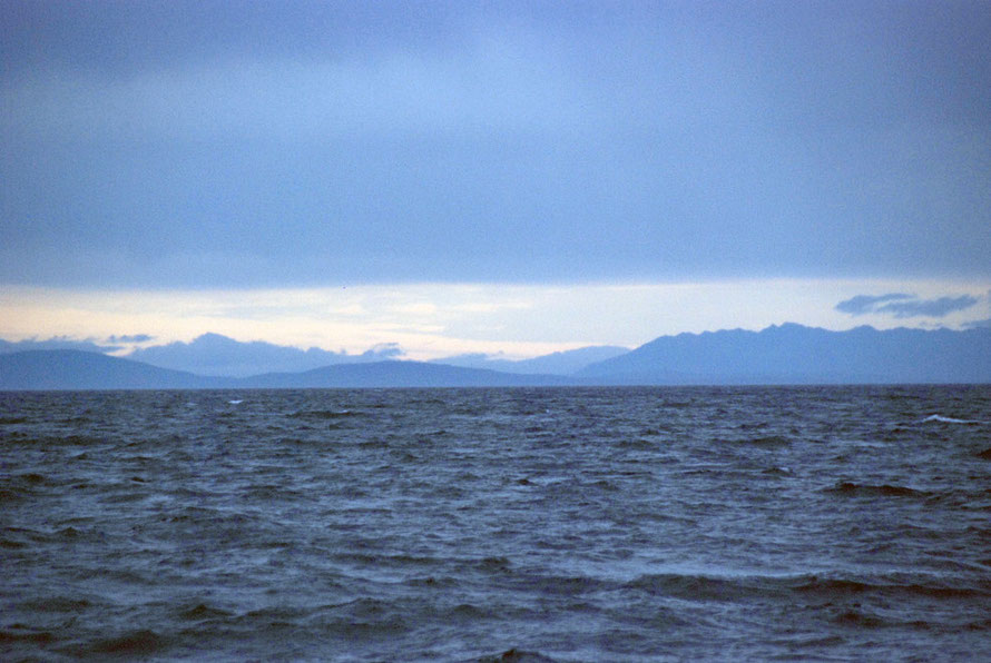 The mountains of Fiordland on the South Island from the Foveaux Strait.