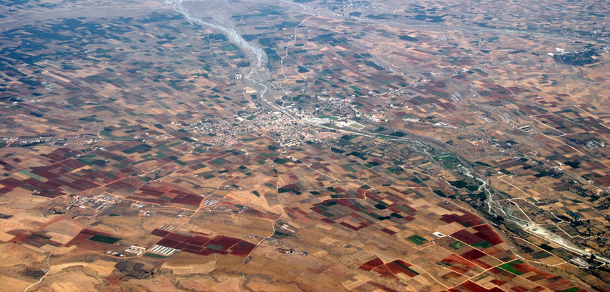 The Mesaoria at Peristerona in June 2012: the river is dry and many of the fields have been harvested and ploughed.  Citurs clutivation intensifies on the lower ground to the south of the village (top