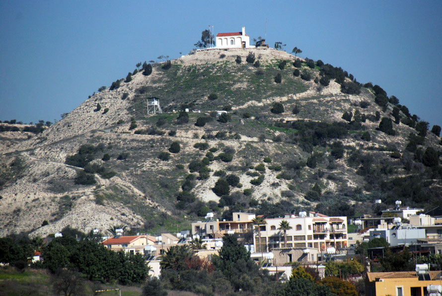 The Louroujina Salient and Green Line above houses on the road to Larnaca. The white raised platform halfway up the hill is a UNFICYPF post in the narrow buffer zone. The hilltop church is a Turkish military post. 