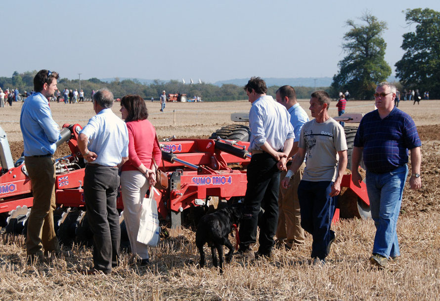 Making the pitch: salesman, punters and Sumo Trio 4 single pass cultivator while others look on at the East Kent Ploughing Match, 2011