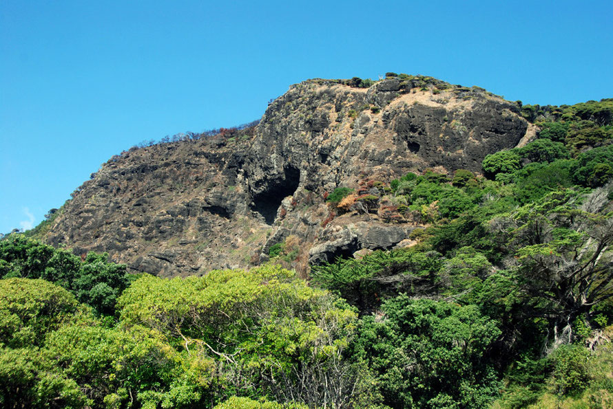 Brutal volcanic rocks above Karakere Beach. 
