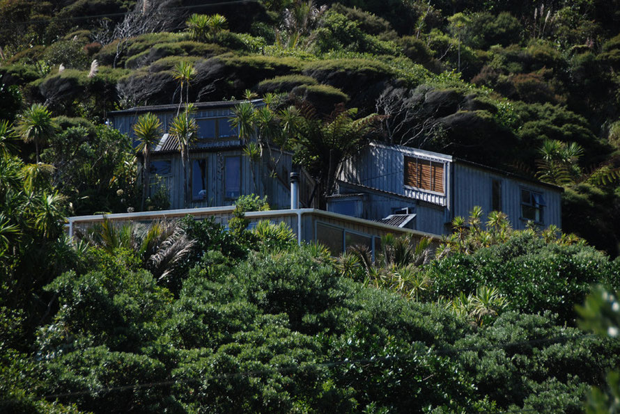 Upscale bach built into the hillside above Karakere Beach. 