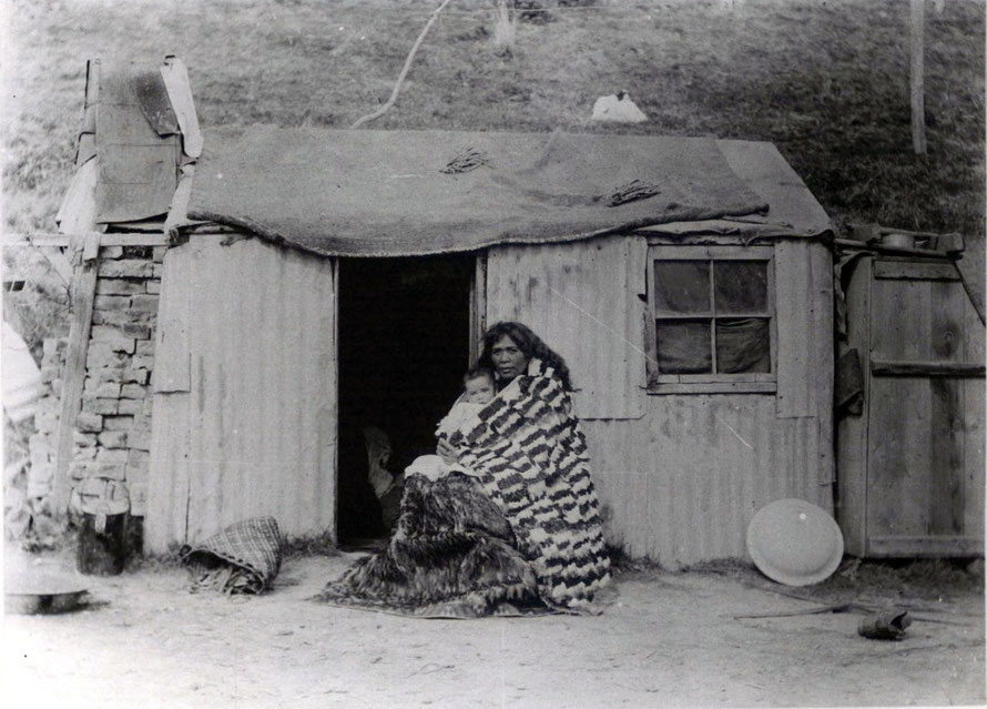 Heni Kiniwai Hampstead (nee Mamura) and her son, wife of Ngai Tahu chieftain Wi Pokuku outside their home in Moeraki north of Dunedin in 1903 (Otago Museum and Hocken Collection)