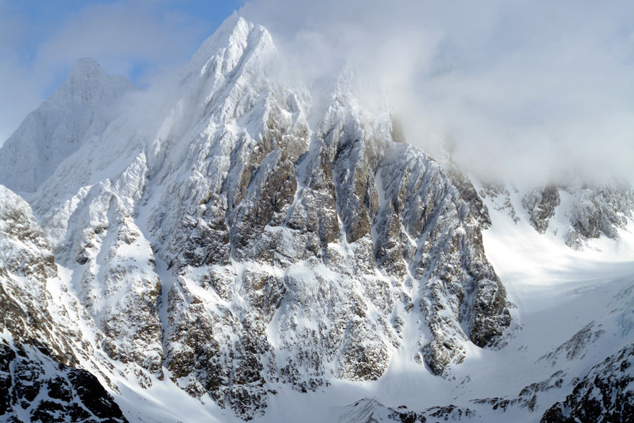 The spectacular face of Store Lenangstinden (1625m) in the northern Lyngen Alps showing clearly layered gabbro thrust to an 80 degree incline. 