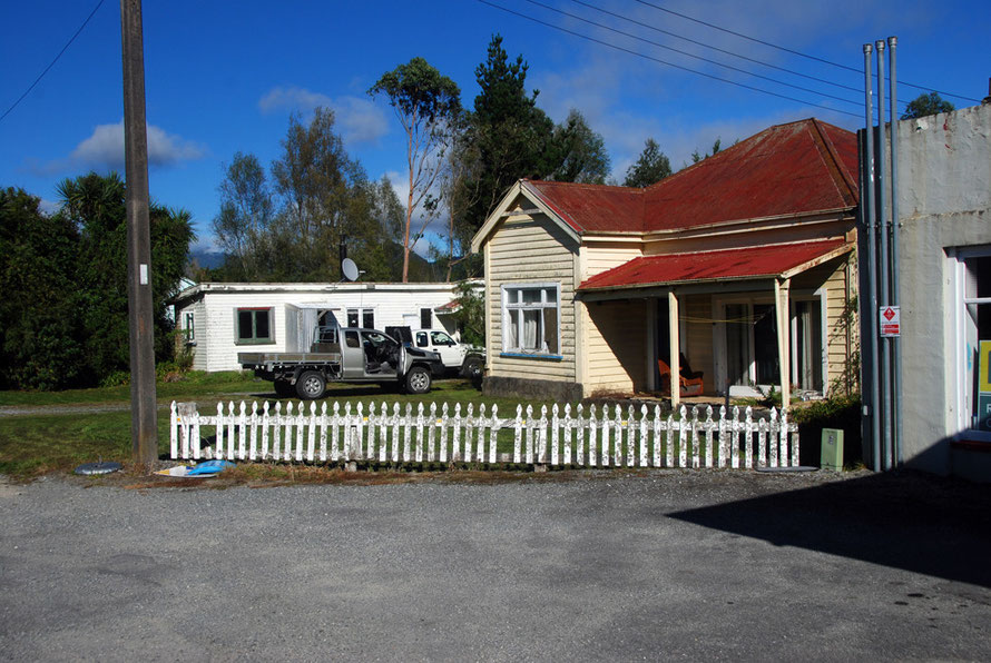 Red roof, picket fence and pick-ups, Whataroa.