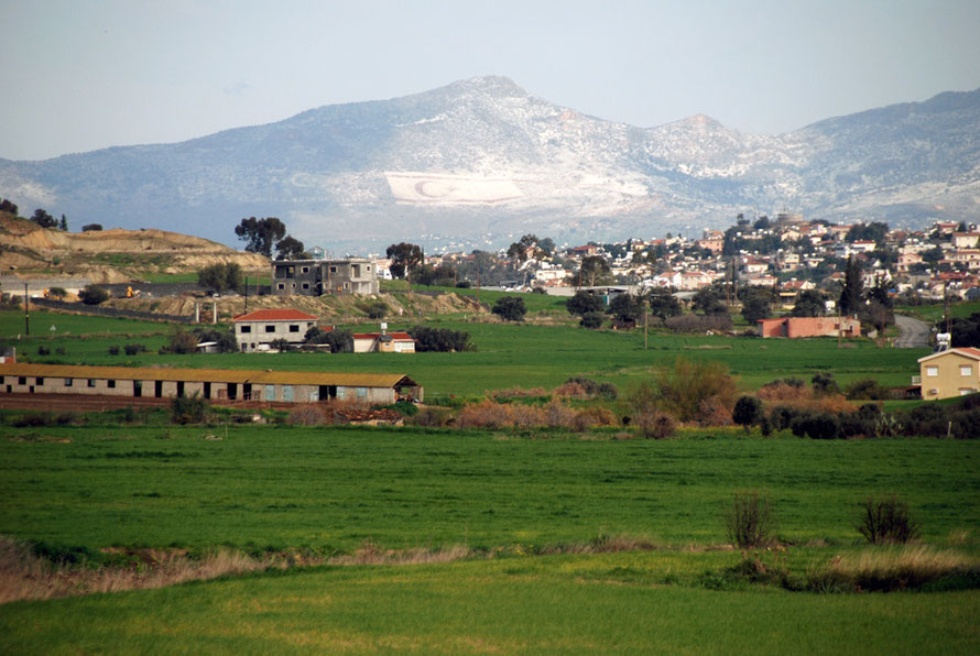 Looking back towards Nicosia from near Tseri  and the ever present flags over the Green Line of the TRNC, picked out by the overnight snowfall