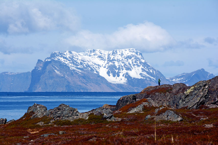 The impressive bulk (750m) of Nord-Fugløya island shimmering in the heat haze seen from the northern end of the Lyngen Peninsula. The island is uninhabited and formed of mica schist.