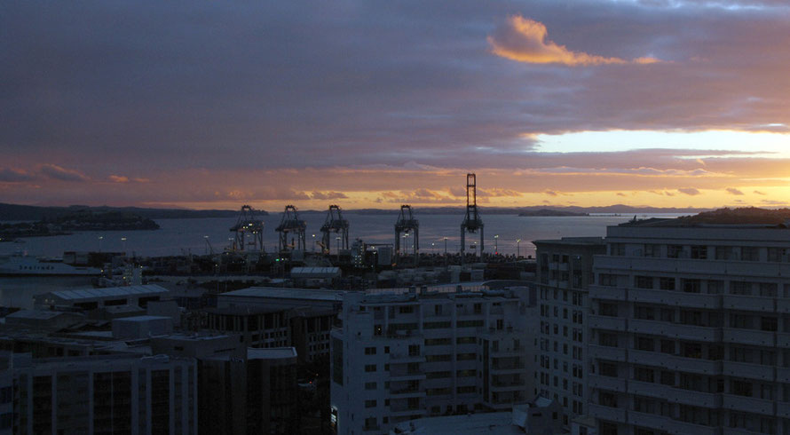 Day breaks ove the Hauraki Gulf and the Auckland Container Terminal.