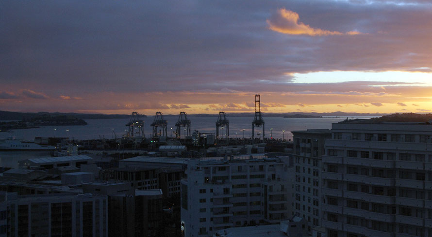 Day breaks ove the Hauraki Gulf and the Auckland Container Terminal.