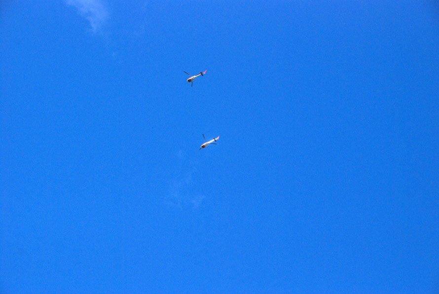 Helicopters stand by to whisk explorers for their five minutes on the glacier.