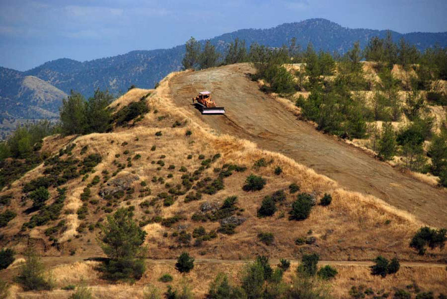 Bulldozer making firebreaks below Kampos