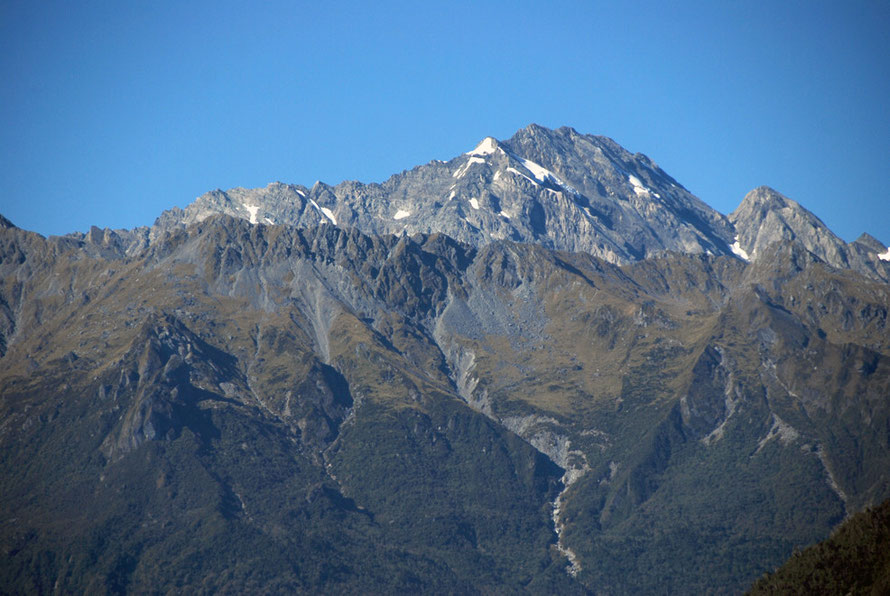 The rocky snow free peak of Mt Fletcher in the Southern Alps with Butler range in foreground