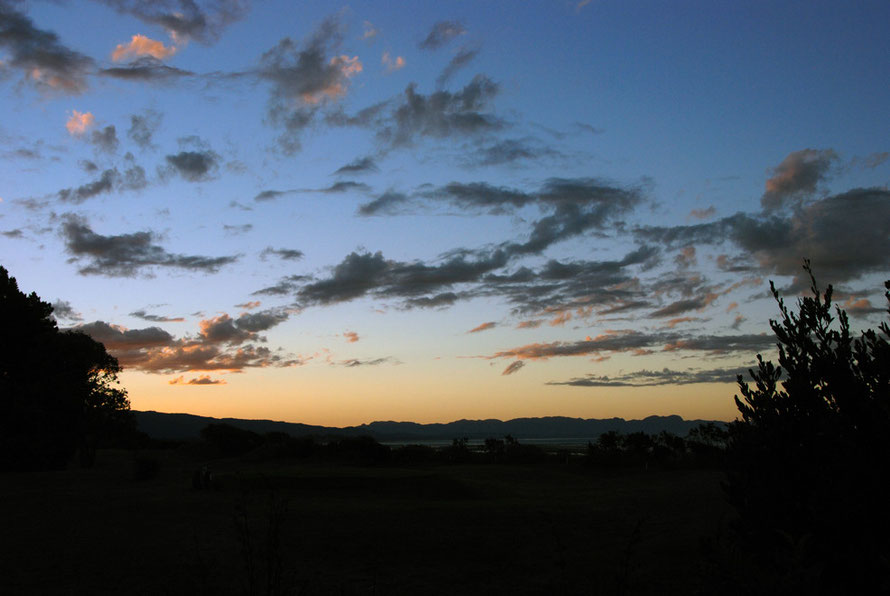 Sunset to the west of Pohara Beach, late summer.