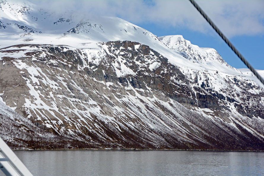 The massive truncated spur of Stortuva mountain (1100m) on the western side of the Ullsfjorden opposite the Lyngen Peninsula. The spur-end is in places over 500m high and has been carved out by a succession of glaciers of immense strength.