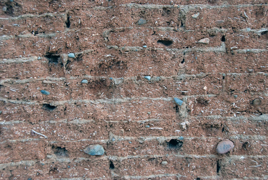 Detail of mud brick wall showing straw and stones in the layers of mortared brickwork, Peristerona.