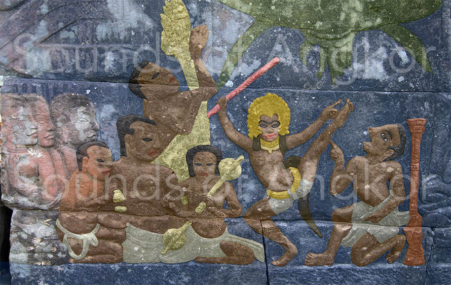 4. In this scene, a character with the enigmatic role surrounds the handle of the harp of his arms, unless it is a second singer. Banteay Chhmar.