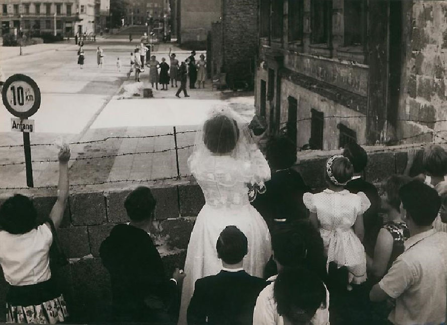 03. September 1961:  Eine Braut winkt an der Ecke Bernauer/Swinemünder Straße (Wedding) ihrer Mutter im Ostteil der Stadt einen Gruß zu. Treffen können sie sich nicht. (www.kas.de) / Konrad-Adenauer-Stiftung