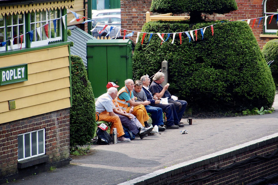 Bunch of blokes eating lunch maybe, at Ropley station obviously, dressed in work clothes. I wonder what their story is? Can't tell.