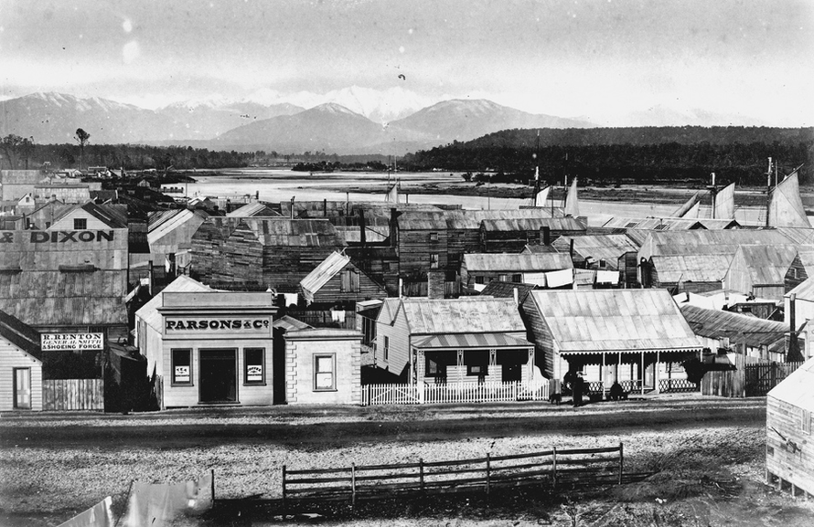 Hokitika c.1870 Revell Street with ships at the wharf in background. James Ring (Alexander Turnbull Library, National Library of New Zealand)