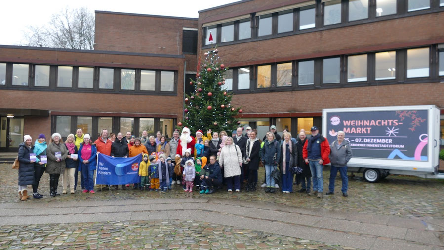 Zur Vorstellung des Weihnachtsmarktes hatten sich der Weihnachtsmann und Vertreter der beteiligten Organisationen sowie die Bären-Gruppe der Kita Zauberbaum unter dem Weihnachtsbaum auf dem Rathausmarkt eingefunden