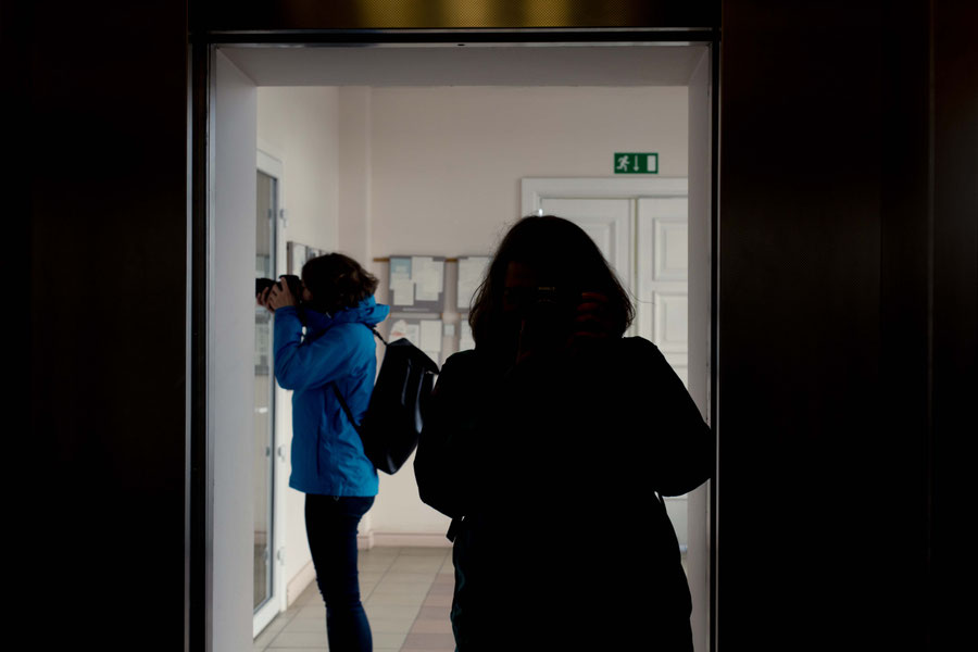 Parallel photography, silhouettes in elevator door